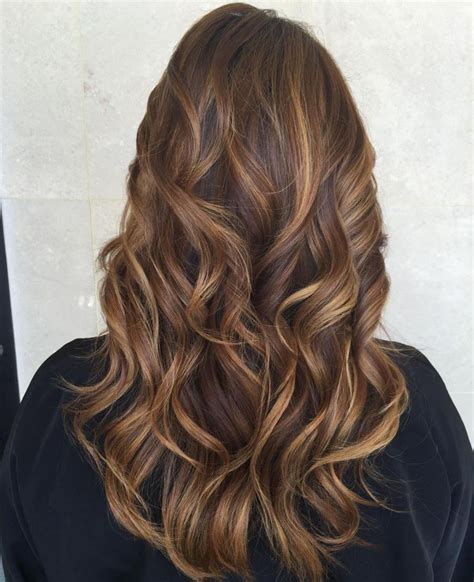 Dark brown hair with caramel highlights is a dark hair color with pops of a brown-orange tint. . Brown hair with caramel lowlights